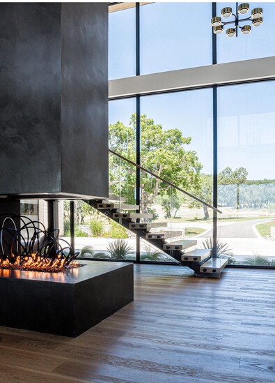 Fire place feature is 3-sided with a suspended chimney