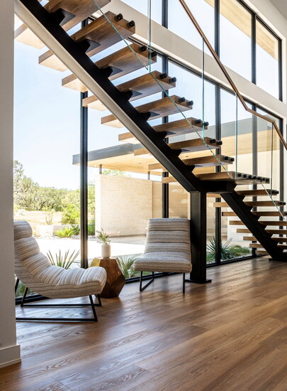 The minimalistic modern, floating stairway does not obstruct beautiful views