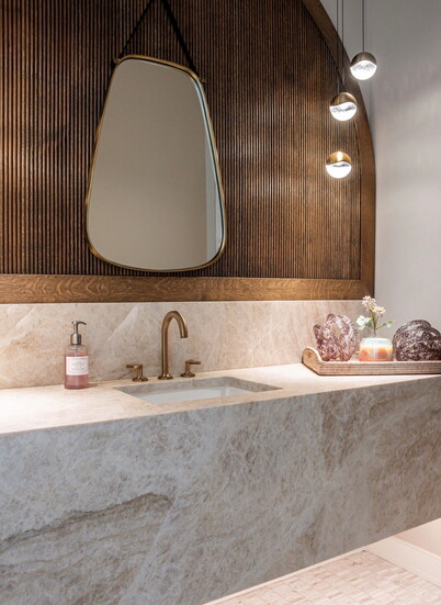 Powder room has floating quartz skirt and red oak paneling