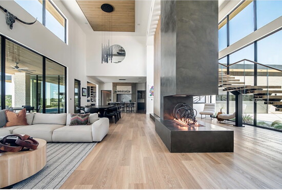 A large sized welcome in the Lines home with suspended chimney open fire feature, floating staircase and large feature windows that open to the views