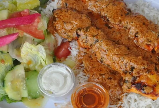 A house specialty—Chicken Tikka Masala with tender, boneless chicken marinated in spices, served in a rich tomato and onion butter cream sauce.