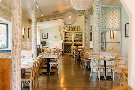 Warm wood tones and rustic charm set the stage for an inviting dining experience inspired by the heart and hospitality of Puglia. Photo: Shel Frances Creative