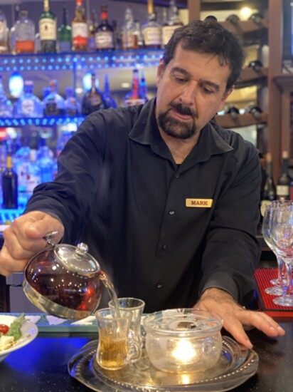 Manager Mark pours a traditional tea at Zorba's.