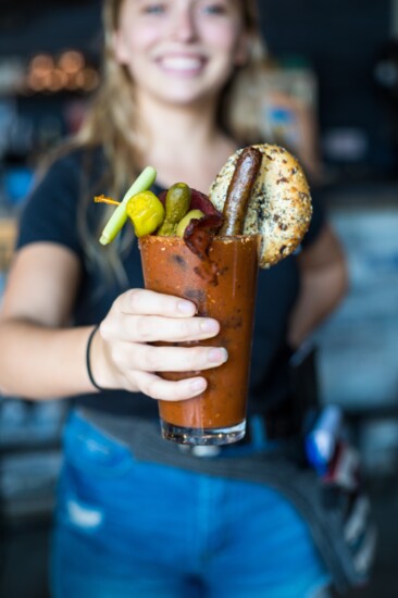 Fully Loaded Bloody Mary, bursting with flavor and featuring an everything bagel, sausage, and many other treats!