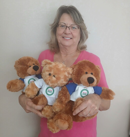 Barbara Bruno of Valley Bloom cradles a new shipment of teddy bears for children in crisis.