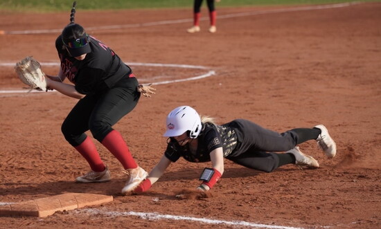 Jaedin Mugleston slides into base during a softball game.