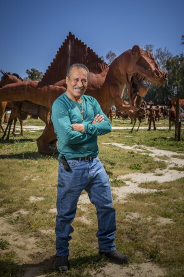 Ricardo Breceda, local sculptor, poses with one of his many unique pieces.