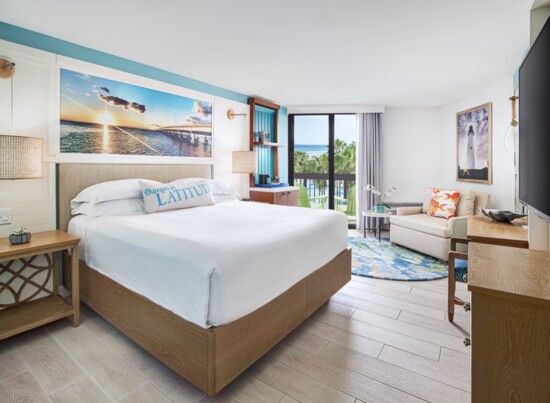Brightly colored suite with a beach view.