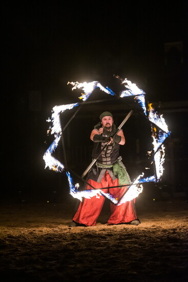 Fire performer commands the night with blazing artistry.