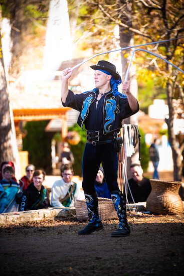 Whip performer amazes audience with precision and flair.