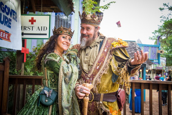 Royal couple greets festival guests in full regalia.