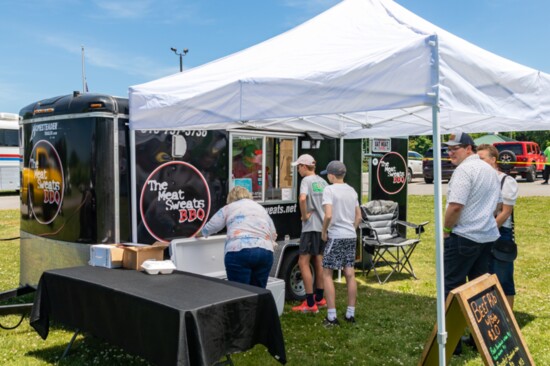 The Meat Sweats food truck is open for business during a community concert.