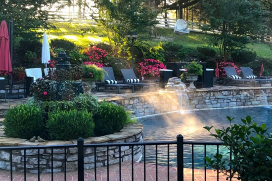 The morning mist over the pool is illuminated at sunrise.