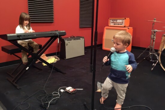 Julia and Jacob "practicing" as their parents set up the rehearsal rooms