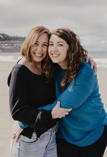 Pam Pannacci and Lyssa Uchida of Amie House share a warm embrace of friendship.