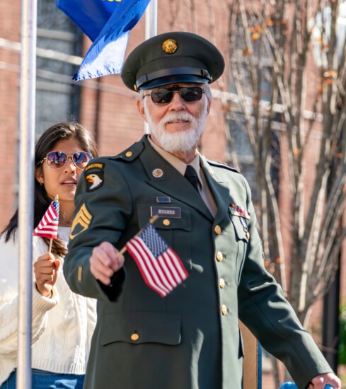 Veteran Tom Hughes waves during the 2023 Gallatin Veterans Day parade.