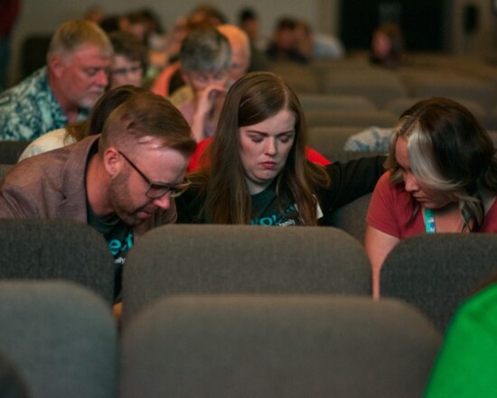 111Project Regional Manager Ryon Moore and his wife, Toni Rae, pray with DHS worker Christina Cabbiness at the inaugural 2023 Church Summit.