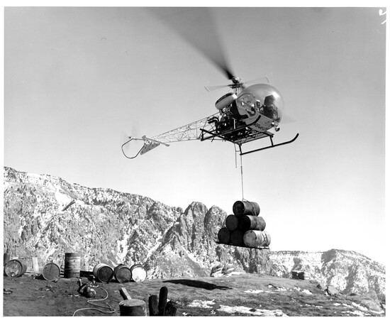 Helicopter delivering materials, early 60's