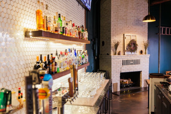 Anderson's full bar experience next to an original 1900s fireplace 