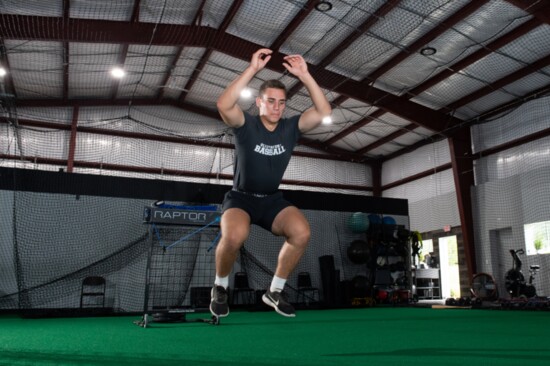 Athlete training with resistance bands using the "Raptor" machine.