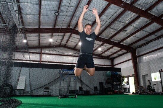 Athlete training with resistance bands using the "Raptor" machine.