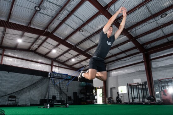 Athlete training with resistance bands using the "Raptor" machine.