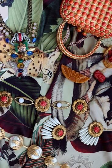 Clara Kasavina bag. Castlecliff pearl and stone earrings and necklace. Orange and red Bakelite pins.