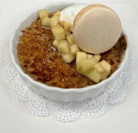 Bourbon Spiced Chai Crème Brûlée, cinnamon roasted apples, cardamom whipped cream, salted caramel French macaron