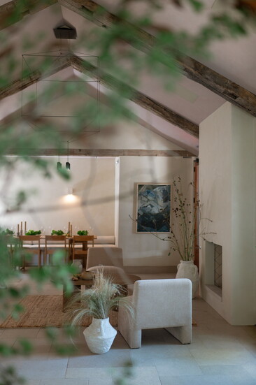 Glimpse into The Harvey dining room set with fireplace lounge seating