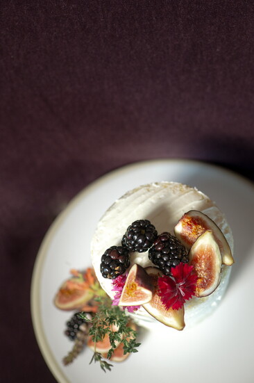 Lemon curd and vanilla swiss buttercream naked cake with fresh berries, figs and thyme