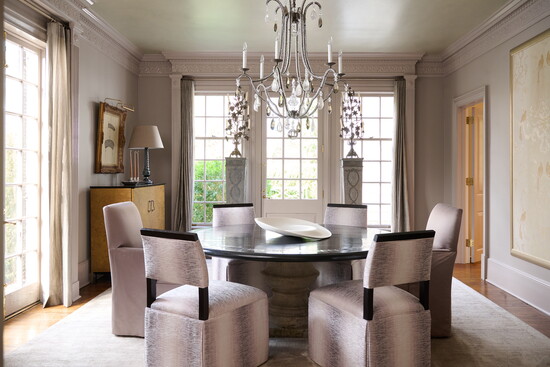 Above: Grounding the room is a cast-stone base dining table with a patinated ebony top by Formations. Seating includes Formations armchairs and Hickory Chair