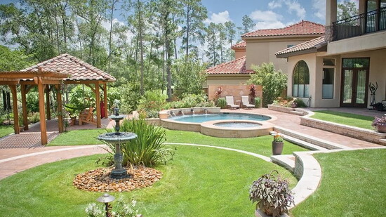 A resort style backyard blends pool, spa, lawn, and a shaded pavilion into one cohesive plan, with pathways that guide flow and protect planting beds.