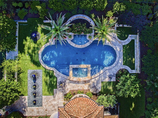 An aerial view shows how pool shape, decking, and planting zones work together, proving why a full site plan matters before construction begins.