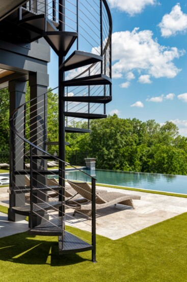 The custom home offers two tiers of exterior living space.