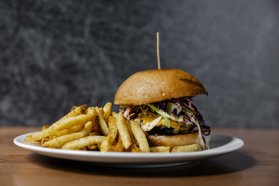 Photo Credit: Lauren Holub Photography Denver Roast Sandwich – Braised beef, sauteed onion, cheddar, coleslaw, horseradish sauce. 