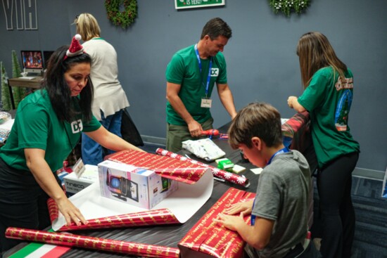 Volunteers wrapping gifts for the Christmas Dreamland.