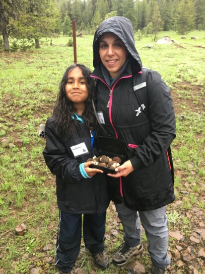 At his first mushroom foray with SIMA in 2022, Noah Romero proudly displays the morels and oyster mushrooms he found with his mother Jamie Romero.