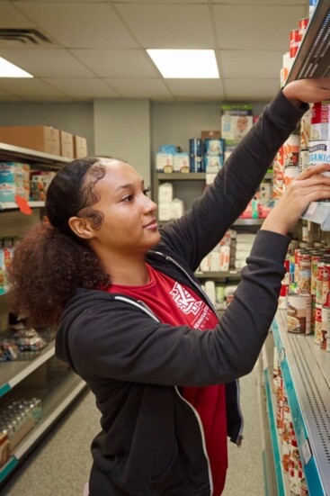 Alexia Mason stocks shelves in the Choice Food Pantry