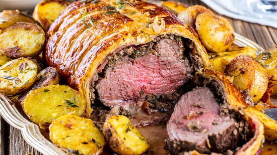 Culinary perfection. Indulge in the rich, flaky elegance of the classic Beef Wellington—a true holiday centerpiece.