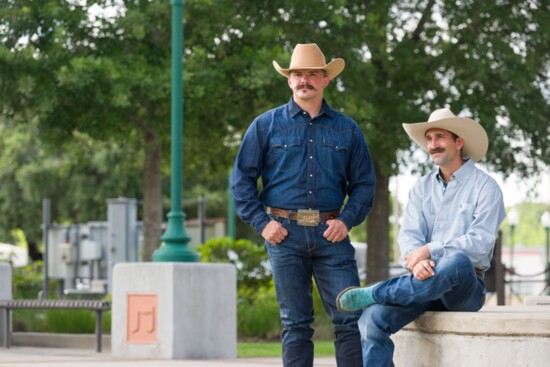 Both men are wearing Cinch white label jeans and Cinch shirts. Left cowboy hat by Double R Hat House, right cowboy hat is handmade by Catalina's Hat Co. 