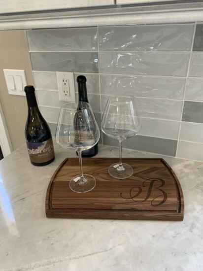The Creative Contracting and C3 Arcitecture teams left a gift of wine, glasses and a custom cutting board for the homeowners to enjoy in their new kitchen. 