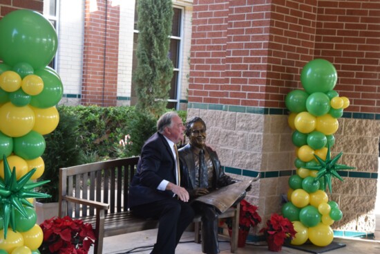 The sculpture unveiled, son Bruce Tough seated beside his fathers sculpture