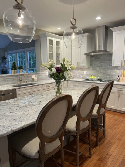 Because everyone always ends up in the kitchen, a large central island and chairs have room to eat.