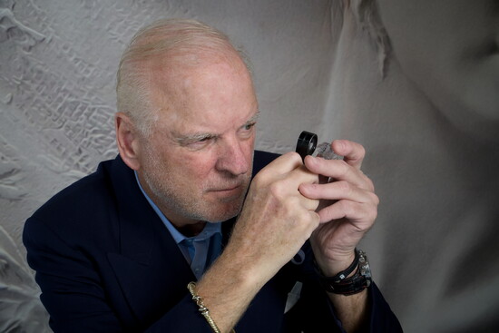 Doron Rozen, Master Jeweler is examining 68 carat diamond in the rough. 
