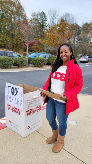 Soror Fareedah Lockhart distributing the gifts for Toys for Tots