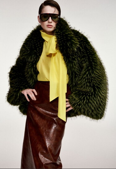 Essentiel Antwerp’s oversized Kastanje faux-fur coat paired with a yellow blouse and brown leather skirt