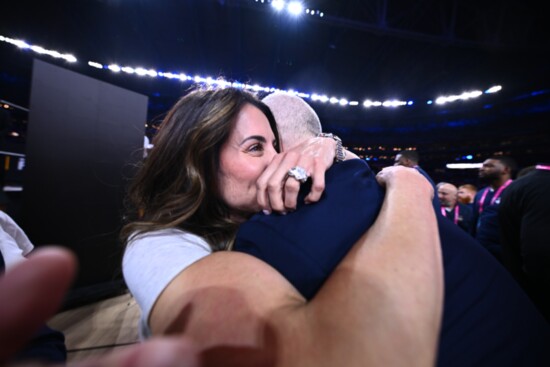 Coach Hurley gets a hug from his wife, Andrea, following a game. 