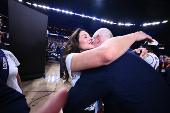 Coach Hurley gets a hug from his wife, Andrea, following a game. 