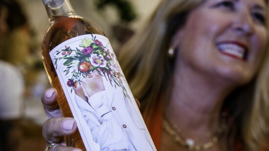 Molly Monson-Stutesman with a bottle of Revelation Rose—the winner of the most Artistic Wine Label