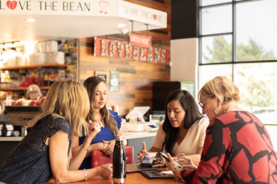 Beth and members of her Corcoran Ferester team hold an impromptu meeting over coffee. 